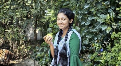 Fifteen year old Sharmin Akter is eating guava, which is a nutritious fruit. She often participates in group discussions in the yard meeting conducted by Concern Worldwide and its partner organizations to gain knowledge about healthy food, health and hygiene, gender, and social safety issues. The Collective Responsibility, Action, and Accountability for Improved Nutrition (CRAAIN) project have educated them to act right about nutrition and safeguarding health. Photo: Mohammad Rakibul Hasan/Concern Worldwide