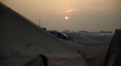 Sun rising over tents in north west Syria