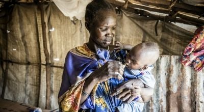 A lady feeds her son in South Sudan