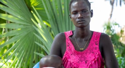 Maria with her son, Goi (2), outside their home in Leer County, Unity State, South Sudan. Photo: Eugene Ikua/Concern Worldwide 