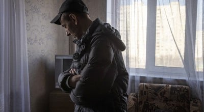 A man looks at the damage in his flat in north eastern Kharkiv due to conflict in the region. (Photo: Ed Ram/Concern Worldwide)