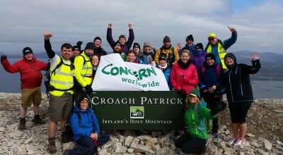 Group of climbers celebrate reaching top of Croagh Patrick