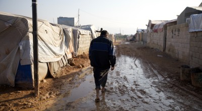 Jaafar* (32) walks through the muddy roads of Ahl al-Khair camp “The condition here is very harsh and staying in a camp is difficult, we did not have any happy occasions in the camp nor any joyful occasion. Do not think that whoever stays here will be happy "This is not true. Anyone who lives here is forced to do so." Photo: Ali Haj Suleiman/DEC/Fairpicture
