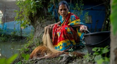 Shochi Ray sorts fish from her today’s catch, releasing the tiny ones back to the pond in Kalinagar, Kamarkhola. Photo: Mumit M/Concern Worldwide