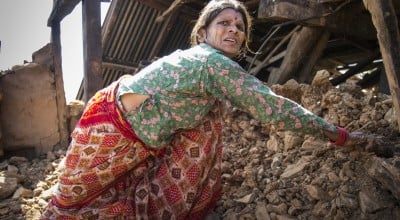 Tulasa Aryal, 58, tries to salvage what she can from her earthquake-ravaged home in Bakrang, a village near the epicenter of the earthquake. A roughly hour drive from Gorkha, Bakrang was among the hardest hit villages in the 7.8-magnitude earthquake that hit Nepal on April 25, 2015. Out of 793 houses homes in Bakrang, 515 were completely destroyed. Photo: Crystal Wells/Concern Worldwide