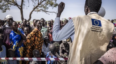 Gatkuoth Matai, Disaster Risk Reduction Officer with Concern South Sudan, speaks to people as they wait for a cash distribution in Chotyiel, Unity State. (Photo: Ed Ram/Concern Worldwide)