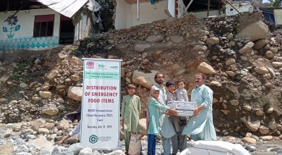 Dry food ration items are distributed to flood affected community members in Pakistan