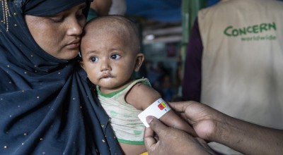 Ayesha*'s malnourished child Anwar* is measured by a Concern health worker in the nutrition center at Camp 13, Cox's Bazar. (Photo: Saikat Mojumder/Concern Worldwide)