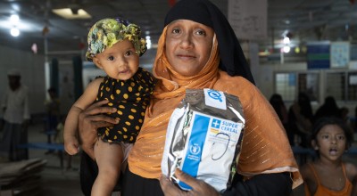 Asmida* , a 35-year-old Rohingya mother, with her child