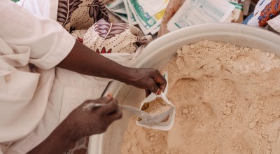 Production of MISOLA® Enriched Flour. Fifteen women from the Afani Yara Women's Group work on the production of Misola. Each 500gr bag sells at 500 cfa. Each child needs 100 gram/day of food supplement for 5 days for recovery. (Photo: Ollivier Girard/Concern Worldwide)