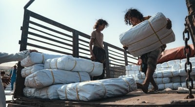 Concern team distribute shelter materials to people affected by the sandstorm that struck Al Anad IDP Camp, Tuban District. Photo: Ammar Khalaf/Concern Worldwide