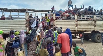 Families board the IOM truck for OTA Photo: CEN.