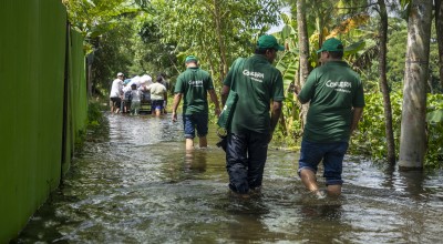 Concern Emergency response team members walk through a submerged road in Noakhali district following the 2024 Bangladesh floods. Photo: Akram Hossain/Concern Worldwide