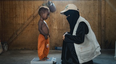 Child being weighed at Yemen malnutrition centre