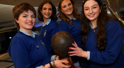 Four people from Ursuline Secondary School holding a trophy after winning Concern Debate final 2026