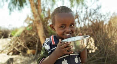 Mursal, 4, drinking water from a bowl in Somaliland