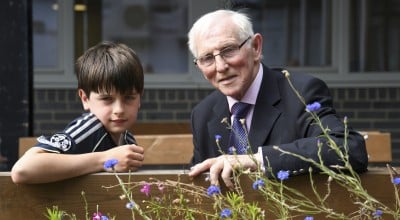 Young boy and Elderly man receive awards for their fundraising efforts