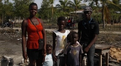 The François family, standing among the rubble of what used to be their home. They evacuated during the hurricane in 2016. Photo: Kristin Myers/Concern Worldwide
