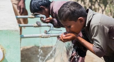 Young boys enjoying a drink at a newly installed water system in Umerkot, Pakistan. Photo: Concern Worldwide. 