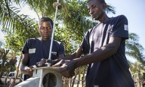 Pump technician, Ilunga Wailungabje (left), and supervisor Daviens Ngoy Wangay (right), doing maintenance work on a water pump in Katchambuyu village, Tanganyika, DRC, September 2017