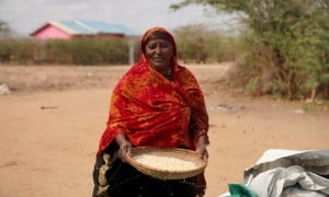 Ralia at her home with her harvested maize which she is currently putting in storage, Tana River, Kenya. Photo: Eugene Ikua/Concern Worldwide.