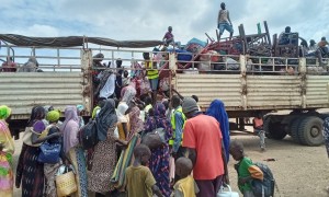 Families board the IOM truck for OTA Photo: CEN.