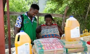Concern's staff with Justa, a small trader in the Cité Soleil area of Port-au-Prince. Photo: Kieran McConville/Concern Worldwide.