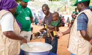 Imenje*, brings his son, Guy*, to receive the nutritious porridge in CAR. Photo: Mussa Uwitonze/Arete/Concern Worldwide.