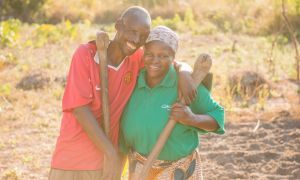 Chibala, 55, and Catherine, 43, work together in their field. Through attending gender training as part of Concern's RAIN programme he has now 'learned to help' his wife. Photo: Gareth Bentley.