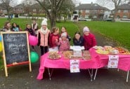 Group of young girls hosting bake sale on their road