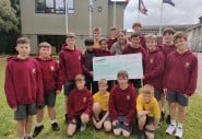 Class from Scoil Assaim BNS Raheny holding cheque for money raised for Concern