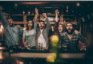 Five people cheer in bar 
