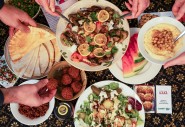  Dinner part scene shown from above. People share Palestinian food. 