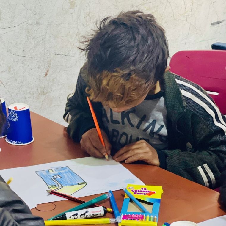 Syrian child drawing in class