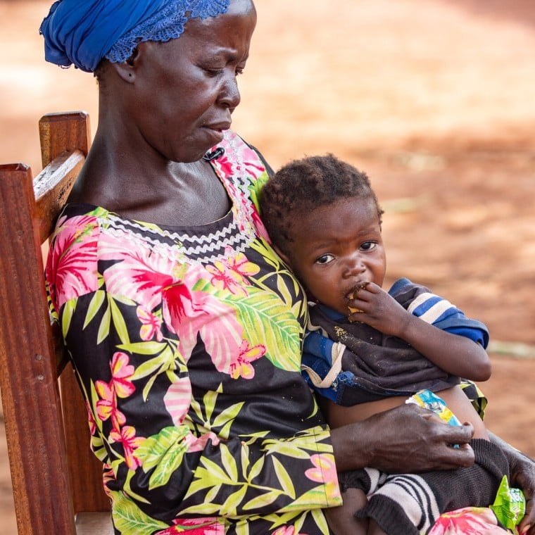 Dominique* holds her orphaned grandchild Sylvie*