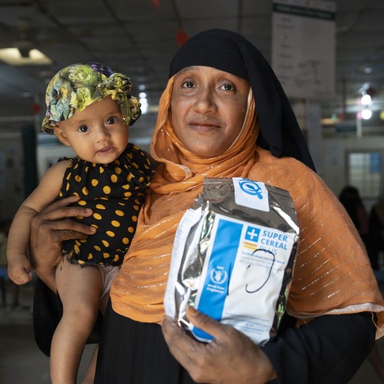 Asmida* , a 35-year-old Rohingya mother, with her child
